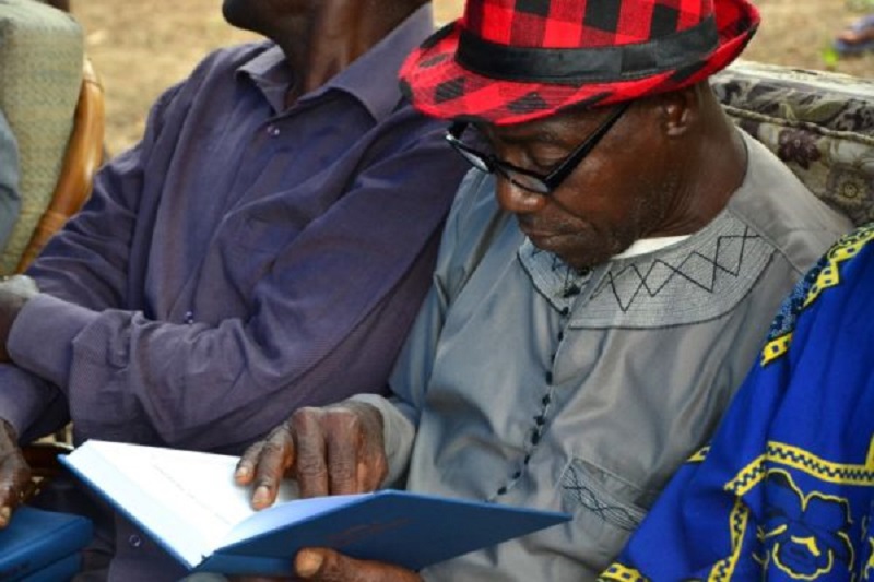 West African man reading his new Bible